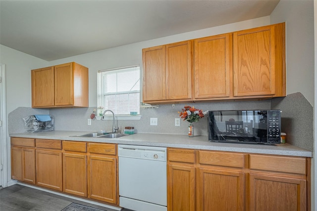 kitchen with a sink, decorative backsplash, dishwasher, and light countertops