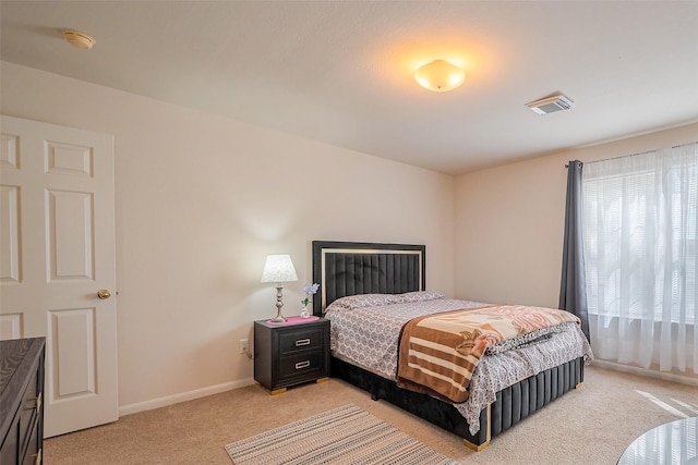 bedroom featuring light carpet, visible vents, and baseboards