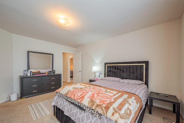 bedroom with baseboards and light colored carpet