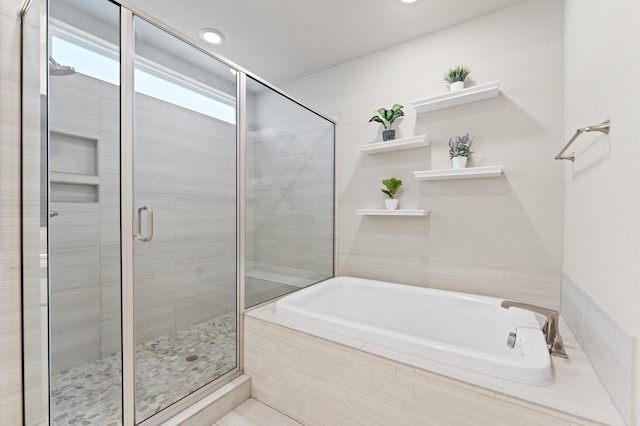 full bath featuring a stall shower, recessed lighting, and a bath