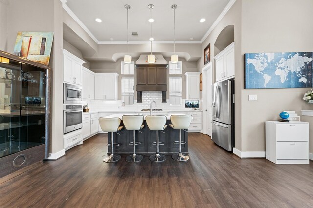 kitchen featuring stainless steel appliances, a sink, light countertops, ornamental molding, and backsplash