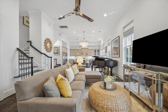 living area with baseboards, visible vents, stairs, light wood-type flooring, and recessed lighting