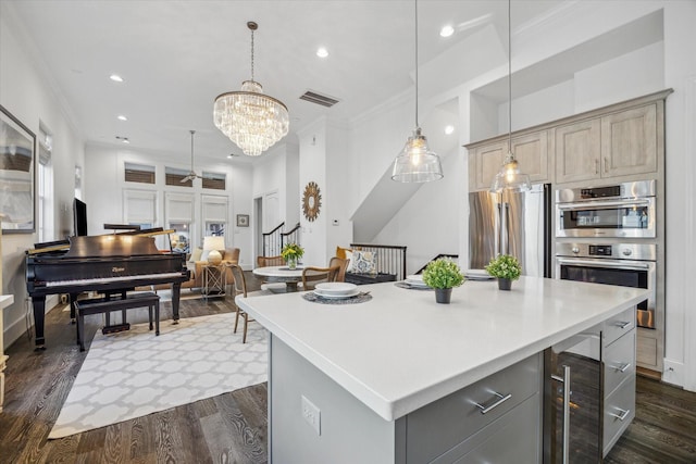 kitchen featuring wine cooler, stainless steel appliances, light countertops, gray cabinets, and dark wood finished floors