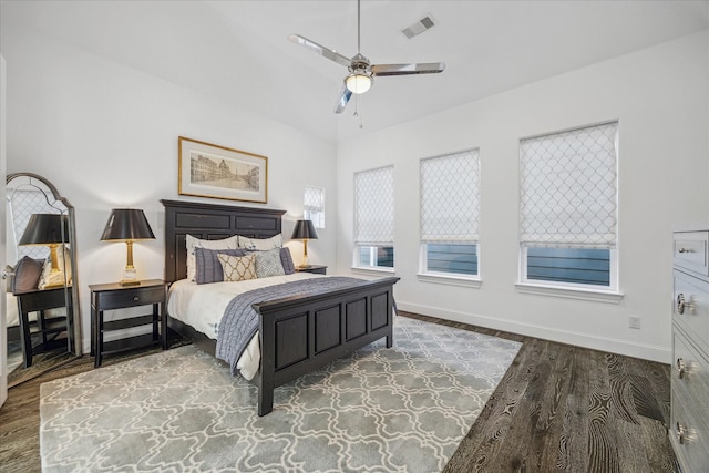 bedroom featuring ceiling fan, wood finished floors, visible vents, and baseboards