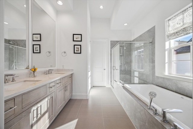 full bathroom featuring a garden tub, double vanity, a sink, a shower stall, and tile patterned floors