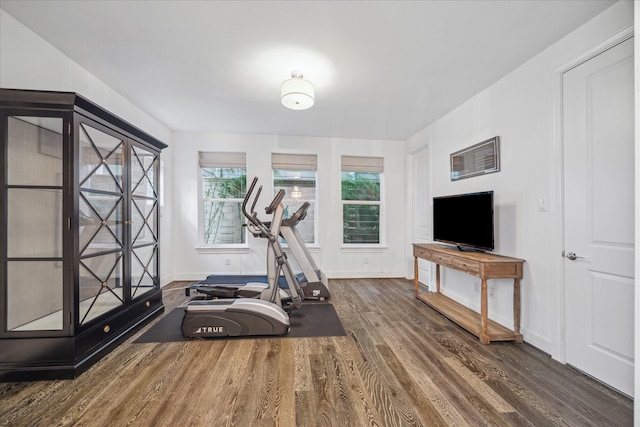 workout room featuring wood finished floors and baseboards