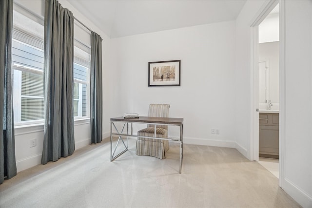 office area featuring light colored carpet and baseboards