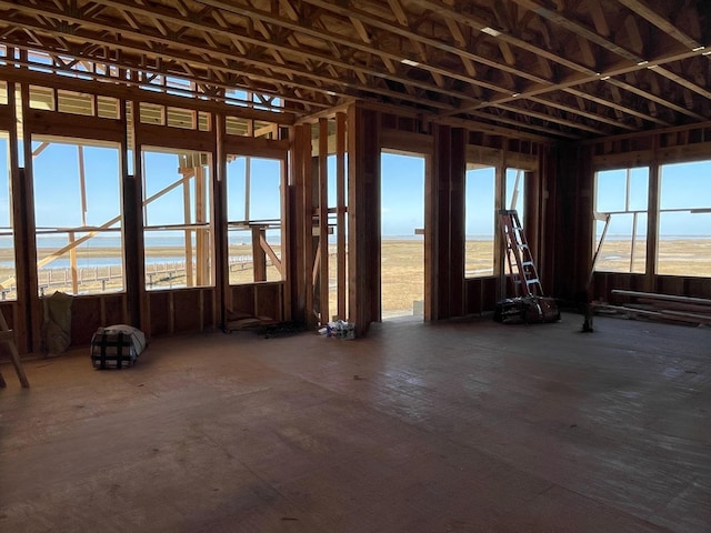 misc room featuring a wealth of natural light and a water view