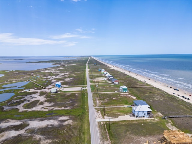 drone / aerial view featuring a water view and a view of the beach