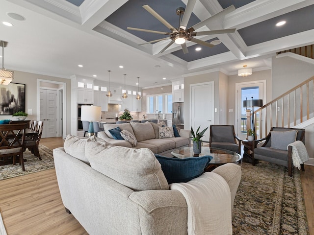 living room with beam ceiling, light wood finished floors, recessed lighting, ornamental molding, and coffered ceiling