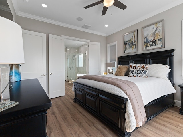 bedroom with ornamental molding, visible vents, light wood-style floors, and ensuite bath