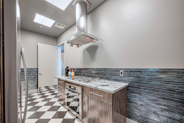 kitchen with stainless steel appliances, modern cabinets, visible vents, and tile patterned floors