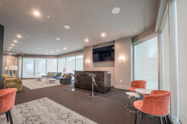 living room featuring baseboards and recessed lighting