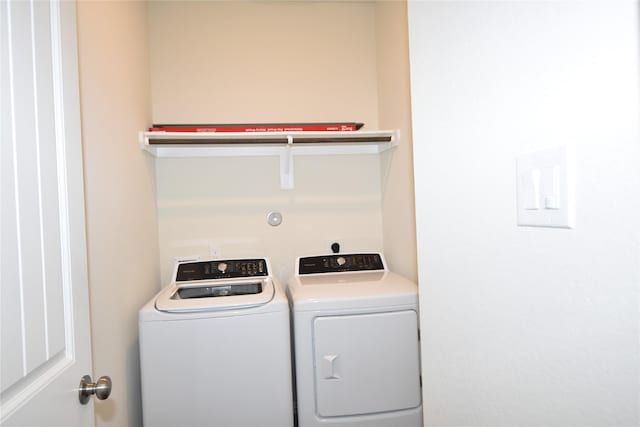 clothes washing area with laundry area and separate washer and dryer