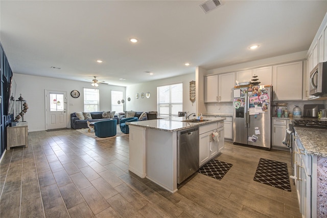 5723 Morning Vista Rd, Katy, TX 77493 - kitchen featuring dark wood-style flooring, stainless steel appliances, visible vents, backsplash, and a sink