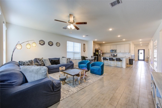 5723 Morning Vista Rd, Katy, TX 77493 - living area with light wood-style floors, ceiling fan, visible vents, and recessed lighting