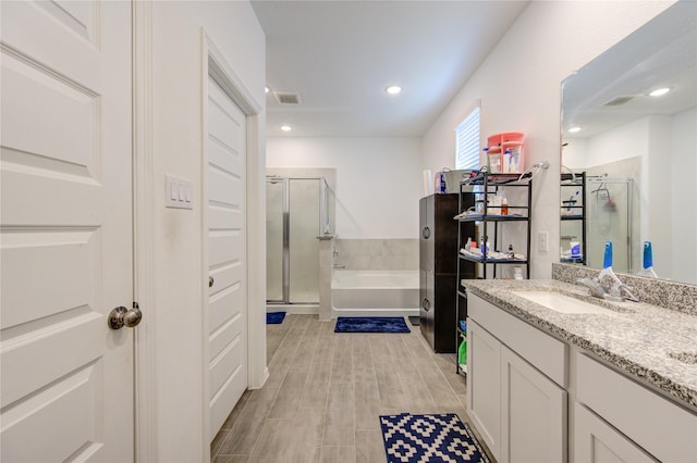 5723 Morning Vista Rd, Katy, TX 77493 - bathroom featuring visible vents, a garden tub, vanity, a shower stall, and recessed lighting