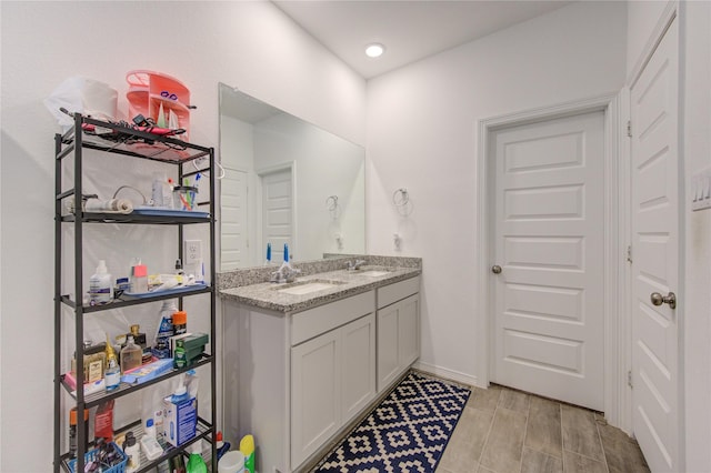 5723 Morning Vista Rd, Katy, TX 77493 - bathroom with double vanity, baseboards, and a sink