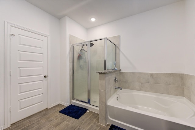 5723 Morning Vista Rd, Katy, TX 77493 - bathroom with recessed lighting, wood tiled floor, a bath, and a shower stall