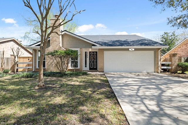 view of front of property with brick siding, a chimney, an attached garage, fence, and driveway