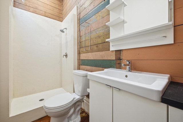 full bath featuring toilet, wooden walls, a shower stall, and vanity