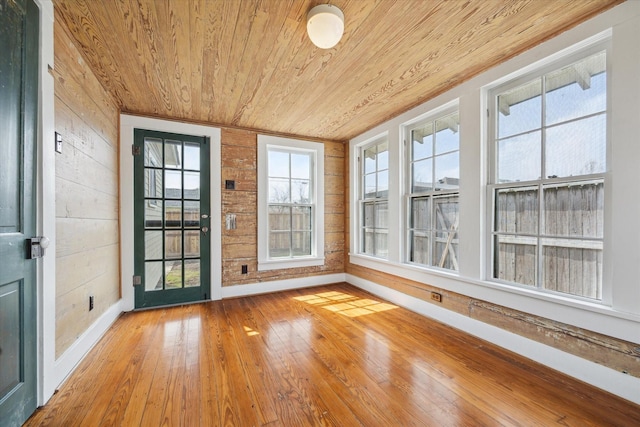 unfurnished sunroom featuring wooden ceiling