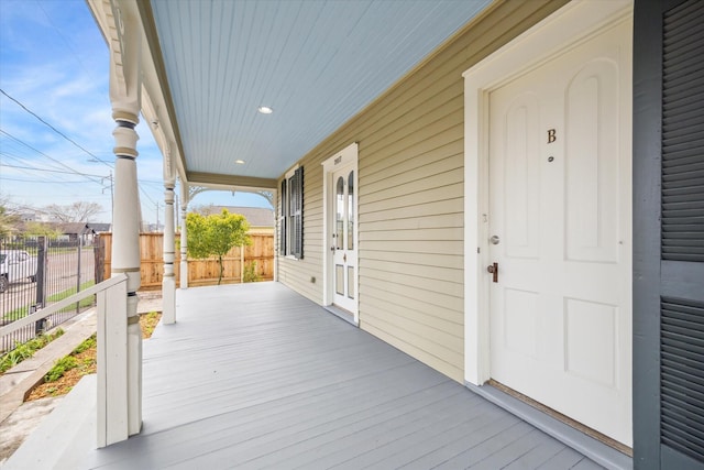 wooden terrace with covered porch and fence