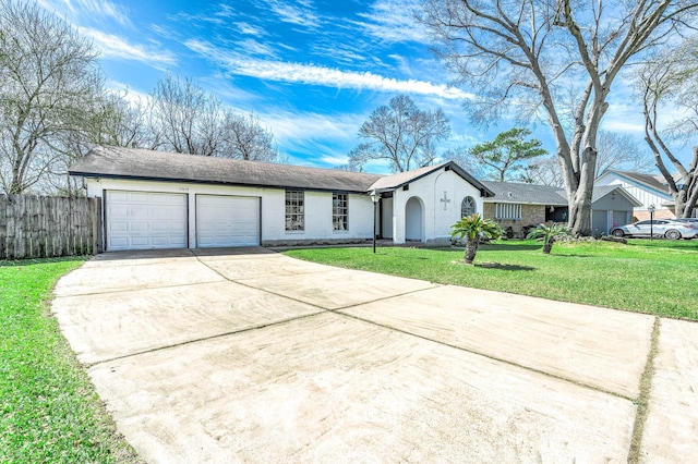 ranch-style home featuring an attached garage, fence, driveway, and a front lawn