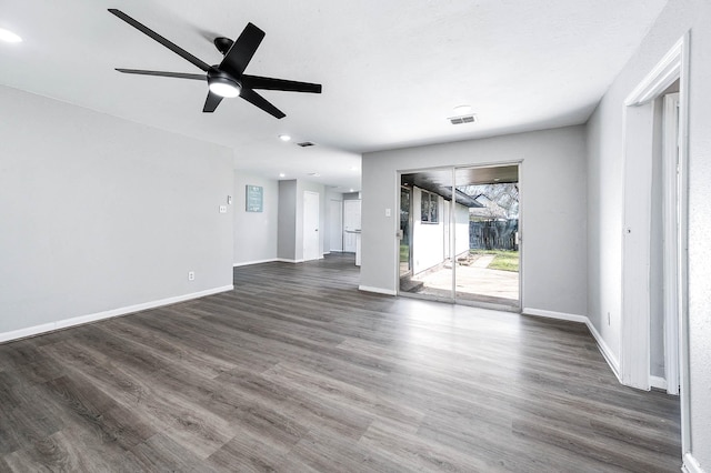 unfurnished living room featuring ceiling fan, wood finished floors, visible vents, and baseboards