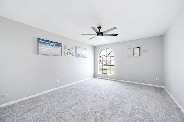 unfurnished room featuring carpet floors, ceiling fan, and baseboards