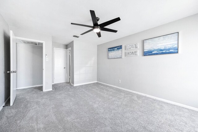 unfurnished bedroom featuring a ceiling fan, carpet flooring, visible vents, and baseboards