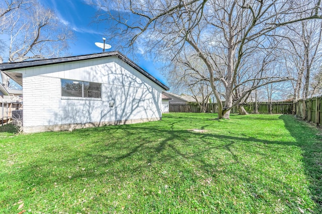 view of yard with a fenced backyard