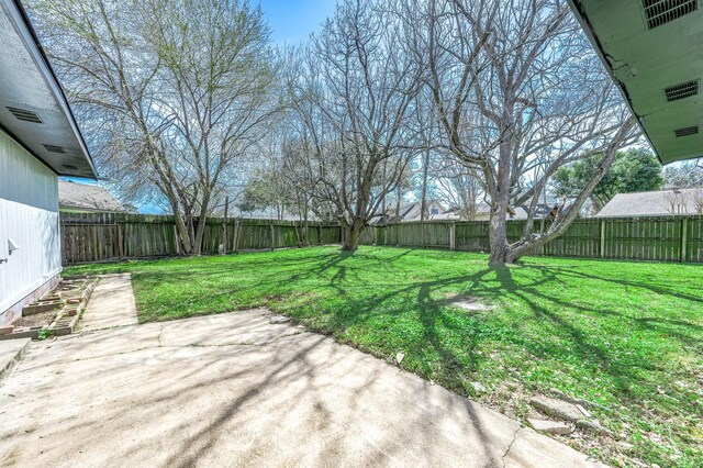 view of yard with a fenced backyard and a patio