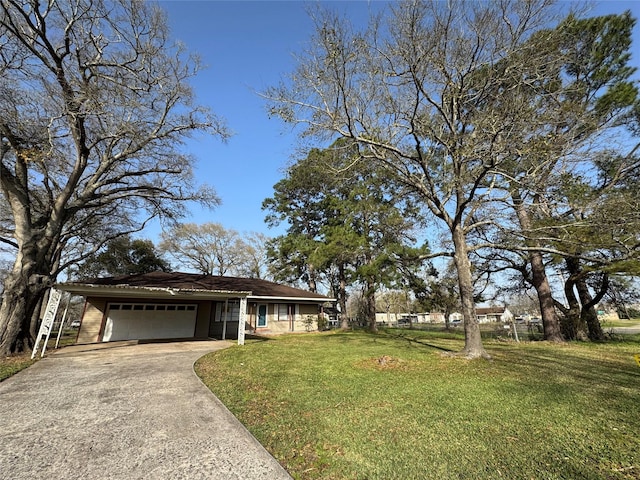 ranch-style home featuring driveway, a garage, and a front yard