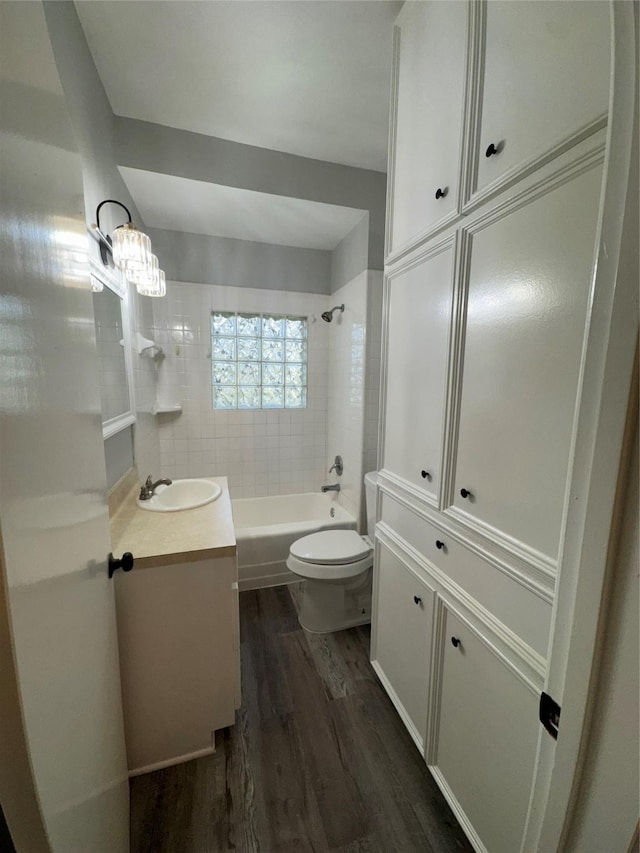 full bath with vanity, shower / tub combination, wood finished floors, and toilet