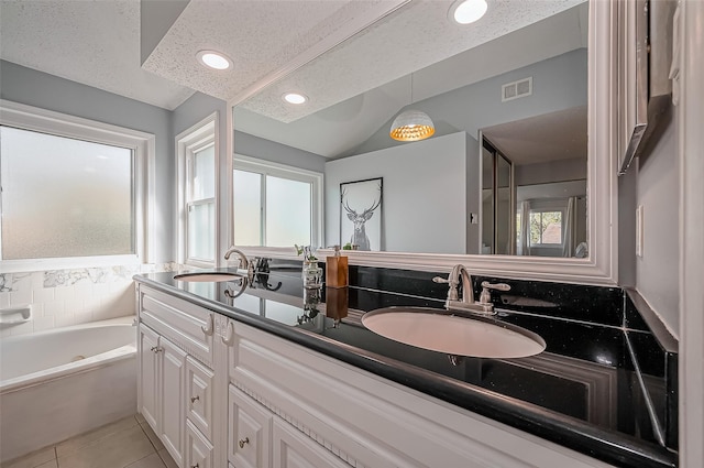 bathroom with tile patterned flooring, a textured ceiling, visible vents, and a sink