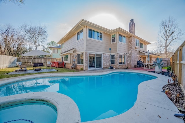 view of swimming pool featuring a fenced in pool, a fenced backyard, a patio, and an in ground hot tub