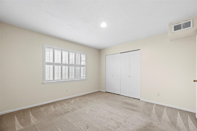 unfurnished bedroom with visible vents, baseboards, carpet, a closet, and recessed lighting