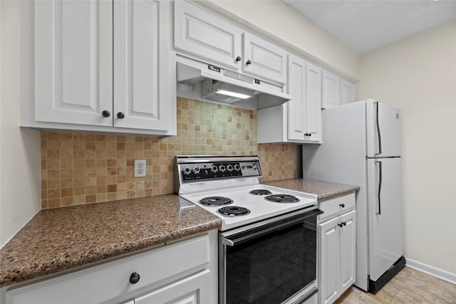 kitchen featuring under cabinet range hood, white appliances, white cabinetry, backsplash, and dark stone countertops