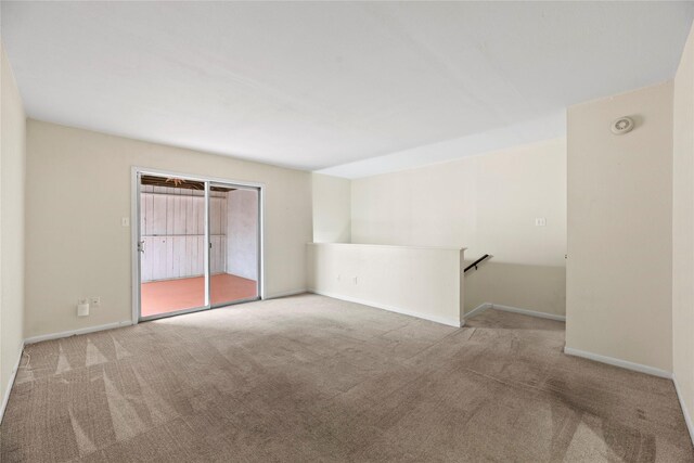 carpeted spare room featuring baseboards