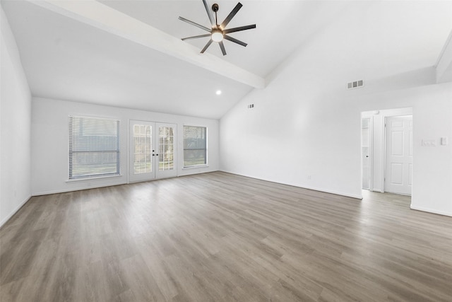 unfurnished living room featuring visible vents, beam ceiling, french doors, wood finished floors, and high vaulted ceiling