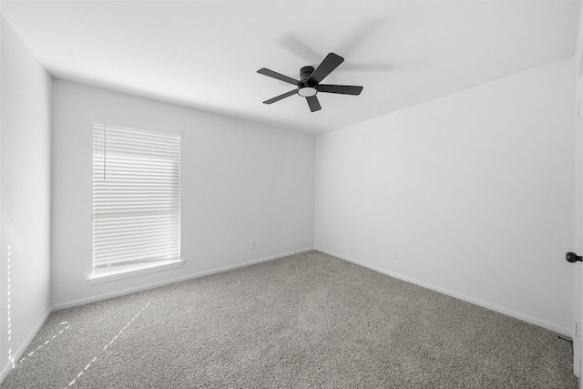 spare room featuring baseboards, carpet, and a ceiling fan