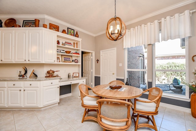 dining space with ornamental molding, an inviting chandelier, light tile patterned flooring, baseboards, and built in study area