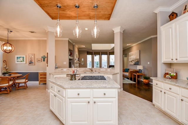 kitchen with visible vents, ornamental molding, light tile patterned floors, stainless steel gas stovetop, and a sink