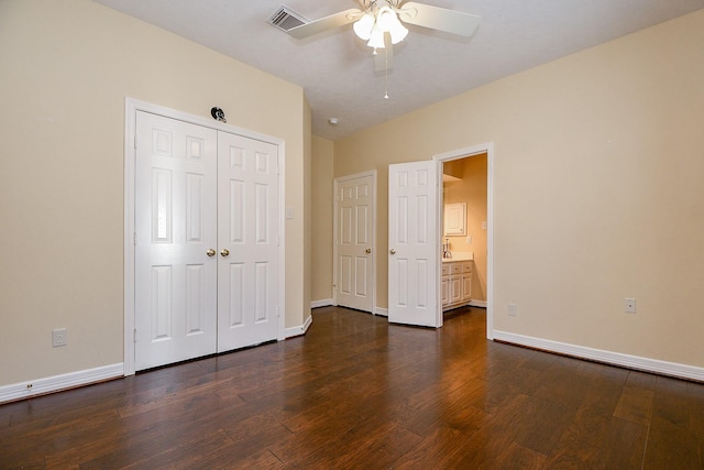 unfurnished bedroom with visible vents, a ceiling fan, dark wood finished floors, a closet, and baseboards