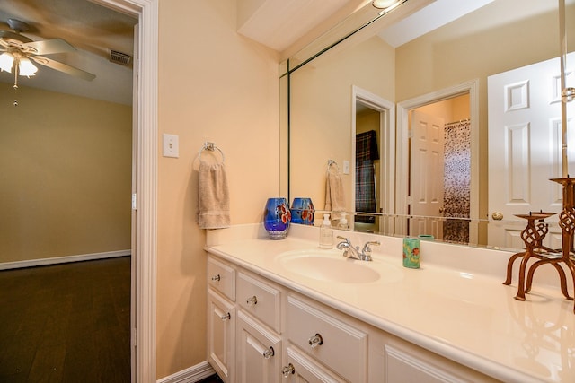 bathroom with vanity, baseboards, visible vents, and a ceiling fan