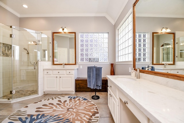 bathroom with a sink, ornamental molding, a shower stall, and tile patterned flooring