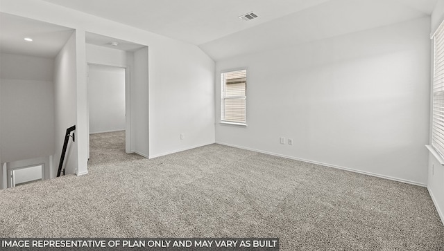 spare room with lofted ceiling, baseboards, visible vents, and carpet flooring