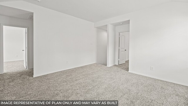 empty room with carpet floors and lofted ceiling