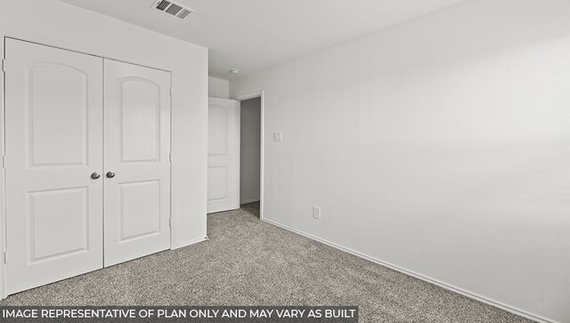 unfurnished bedroom with a closet, carpet, visible vents, and baseboards